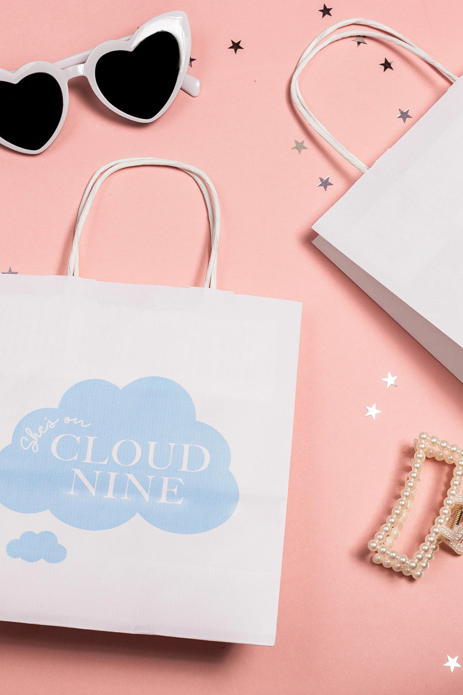 On Cloud Nine theme white gift bags with blue writing for hen party guests 