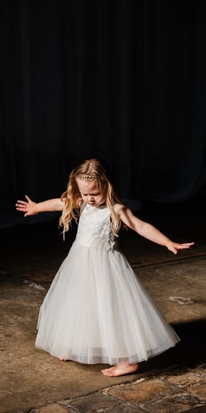 Flower girl dancing in window light 