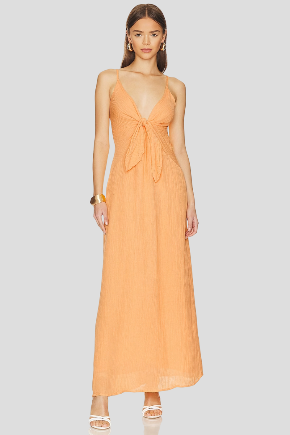 Peach bridesmaid dress from Faithfull the Brand/ Revolve with maxi length and front tie design 