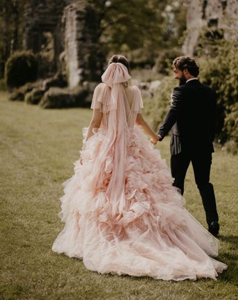 Blush pink coloured wedding dress and bow veil