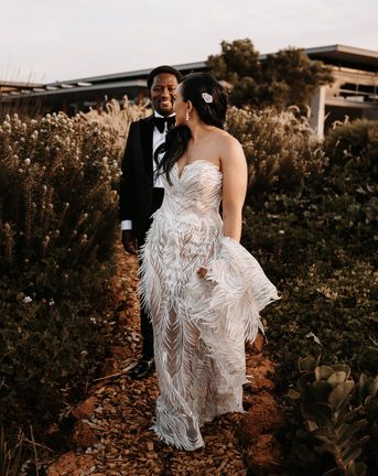 Couture wedding dress with feathers for a luxury, black-tie wedding in South Africa with peach and gold decor and flowers