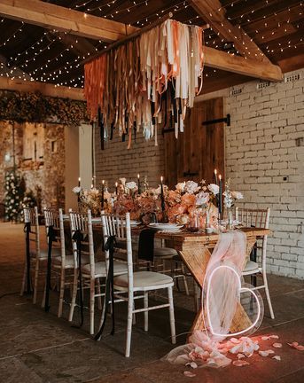 Eden Barn wedding with neon sign, fringe garland and black accent candles