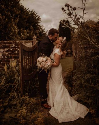 outdoor wedding at Dewsall court with bride in a lace cap sleeve wedding dress