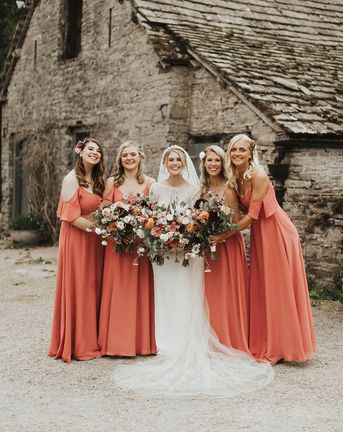 Bride with her bridesmaids in coral bridesmaid dresses from Rewritten Bridesmaids.