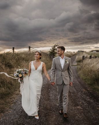 Elmley Nature Reserve wedding with bride and groom walking together