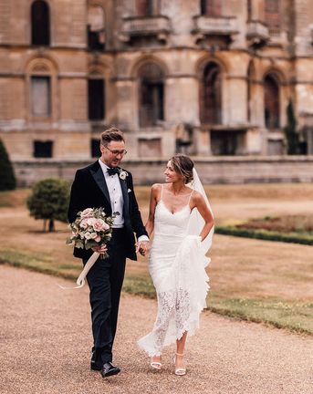 Bride in lace wedding dress and groom in black tuxedo for Hanley Hall Worcestershire wedding.
