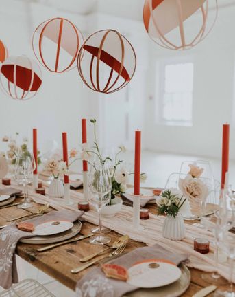 Modern Asian wedding decor ideas with orange and gold colour scheme, lanterns and embroidered napkins
