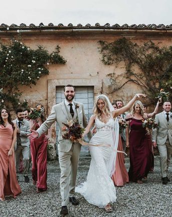 Tuscany destination wedding with lace wedding dress, tambourine favours and terracotta orange bridesmaid dresses