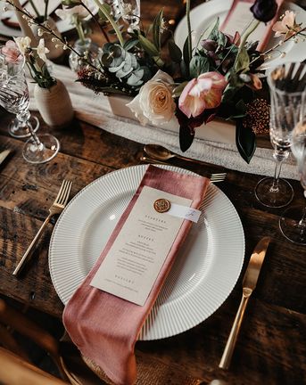wedding menu card on pink napkin for place setting
