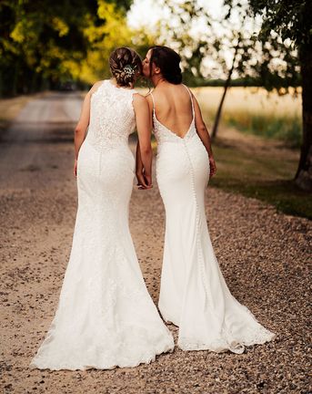 Brides in lace wedding dresses for outdoor summer wedding at Cripps Barn.