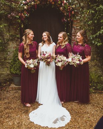 Ramster Hall wedding with bride and bridesmaids in dark red dresses