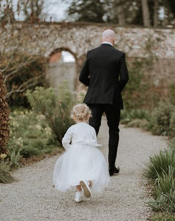 flower girl in white tulle dress with cardigan
