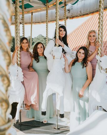Pink and green wedding theme and bridesmaid dresses for carousel fairground wedding.