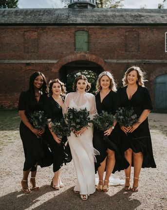 Bride and bridesmaids all holding preserved flower bouquets.