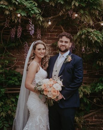 Stanlake Park Wedding with the bride in a lace wedding dress and groom in dark blue suit.