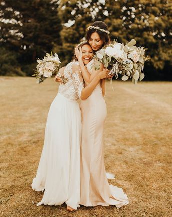 Bride and bridesmaid embracing as you can see the friendship between them