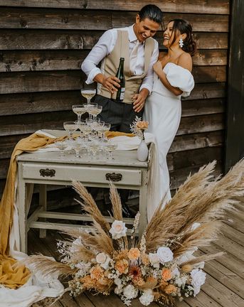 Boho wedding inspiration at The Canary Shed with a muted colour palette, drapes, macrame and wicker wedding decor by Aurora Grey Photography