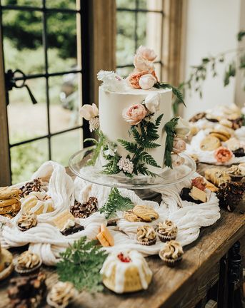 Vegan wedding inspiration with a dessert table and white iced wedding cake.