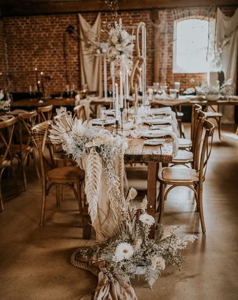 bohemian luxe wedding in a barn with white flowers and natural decor 