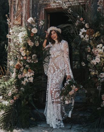 Boho destination Larmer Tree wedding inspiration with palms, muted florals and a lace wedding dress