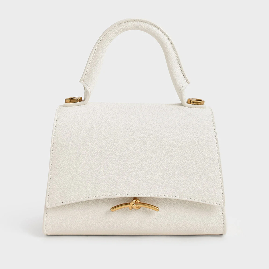 Cream bridal handbag from Charles & Keith with gold metallic accents 