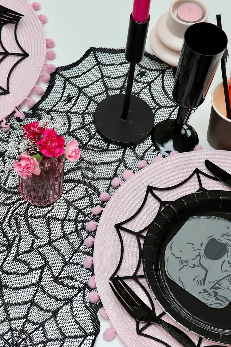 Gothic table decor for hen party theme with lace spider web table runner, black cups, candles and more