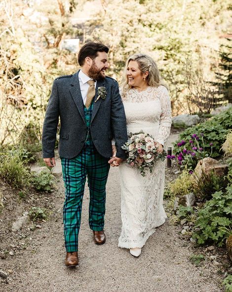 Tartan trousers and lace wedding dress for intimate Scottish pub wedding 