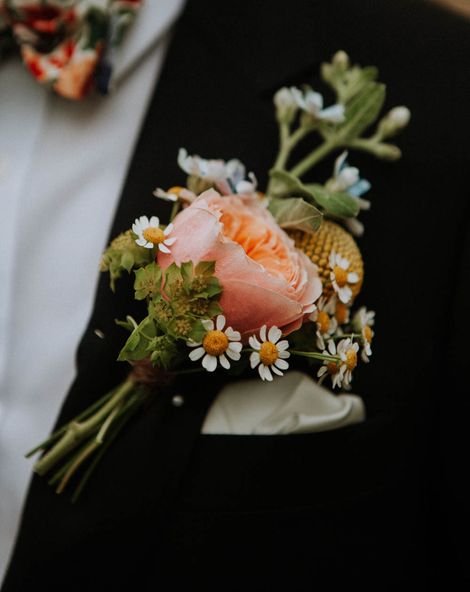 Roundup of stylish groom buttonholes with fresh and dried flowers, foliage, feathers and pins.