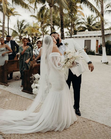 Modern Blue Venado beach wedding with white wedding flowers, disco balls, candles and black bridesmaid dresses by Andre Gouin