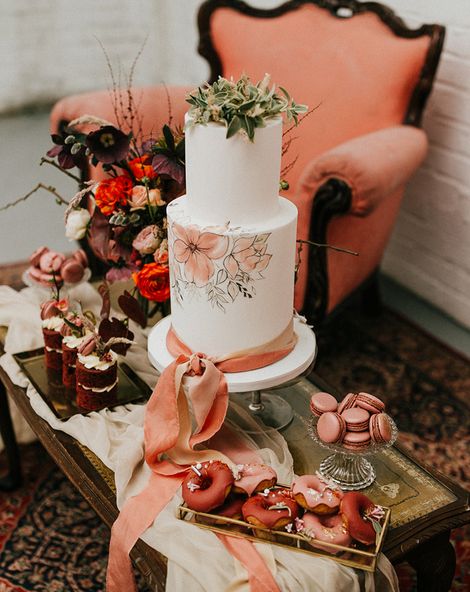 painted wedding cake and terracotta wedding inspiration in an industrial wedding venue