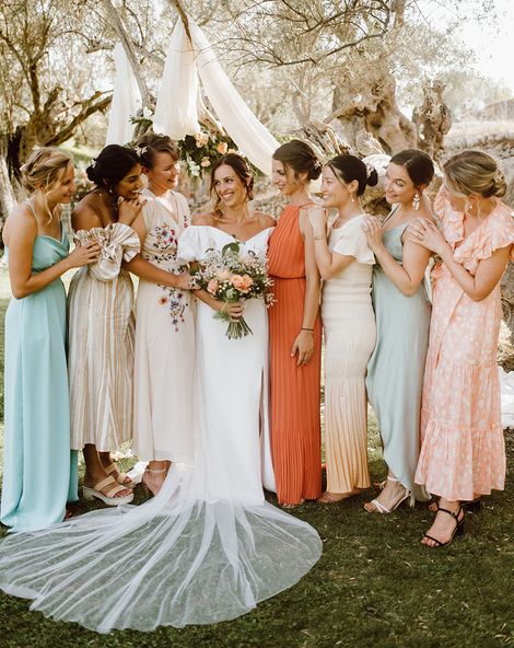 Bride with her bridesmaids in mismatched bridesmaid dresses for destination wedding.