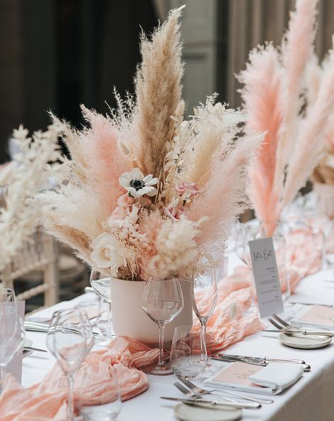 Pink and white pampas grass centrepiece decor for boho wedding.