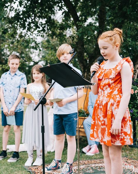 Child performing a reading at a wedding from children's wedding readings.