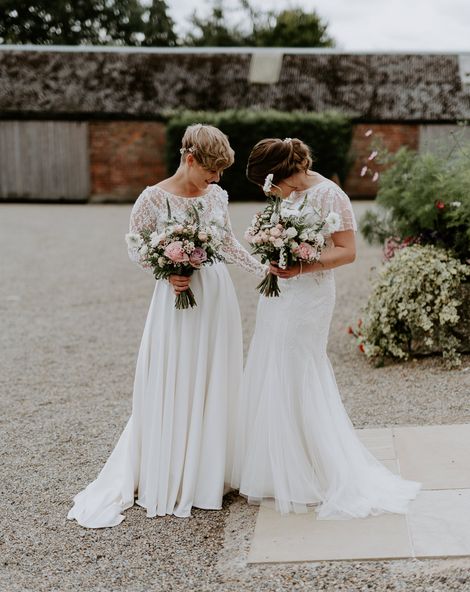 Lesbian couple at Woolas barn wedding with lace and embellished wedding dresses 