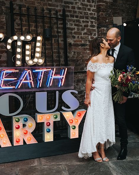 High Street Wedding Dress for an Intimate Crouch End Pub Wedding with Bright Flowers and 'Til Death Do Us Party Neon Sign, shot by Miss Gen Photography