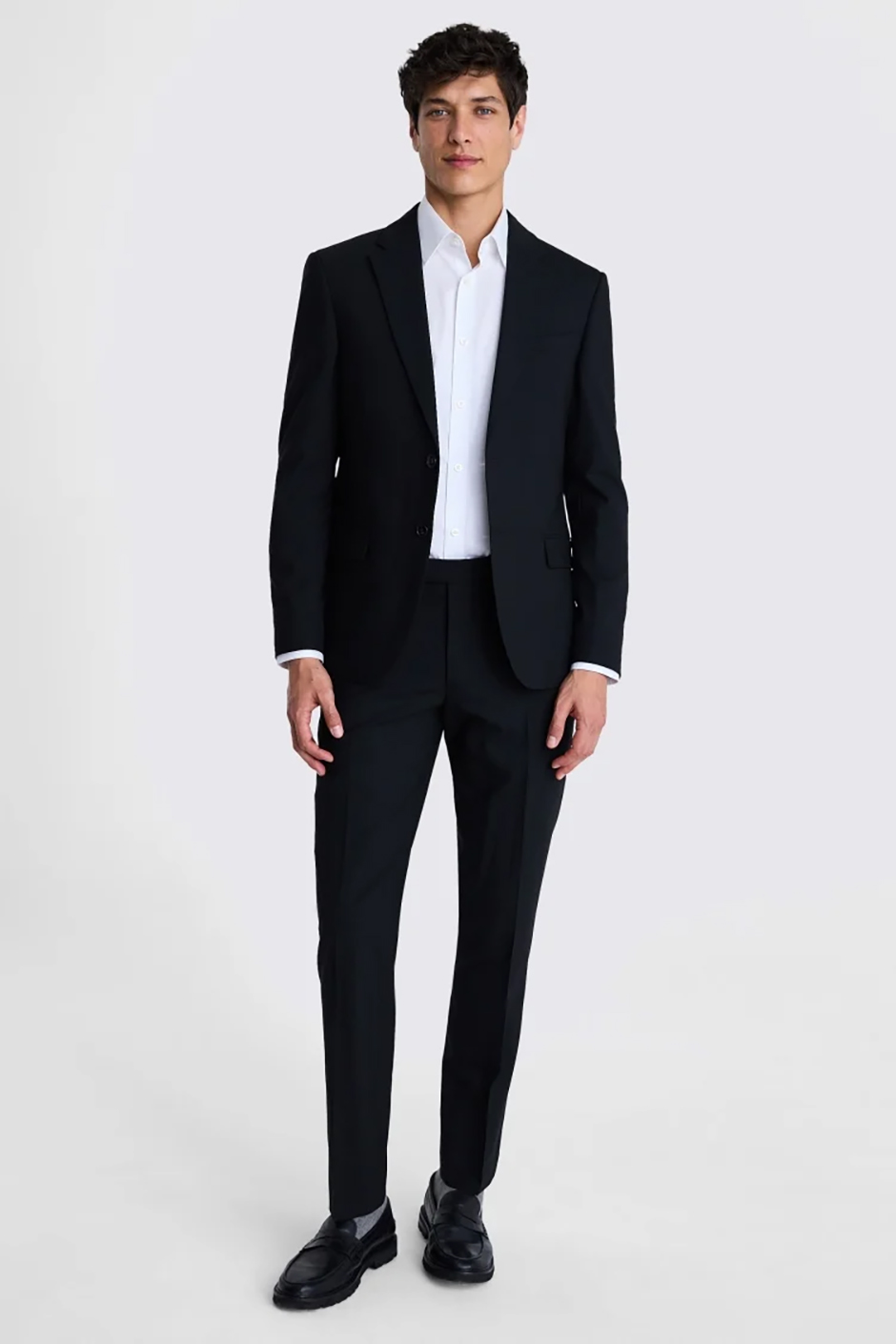 Slim fit black groomsmen suit from DKNY available at Moss Bros, modelled with white shirt under