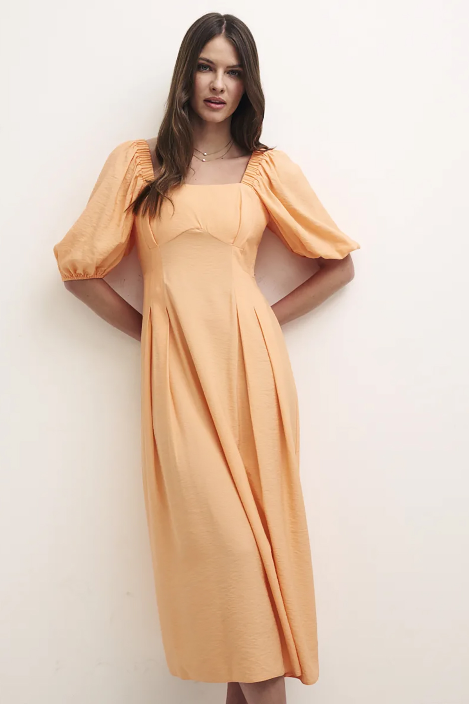 Orange peach bridesmaid dress from Nobody's Child with puff sleeves and midi length 