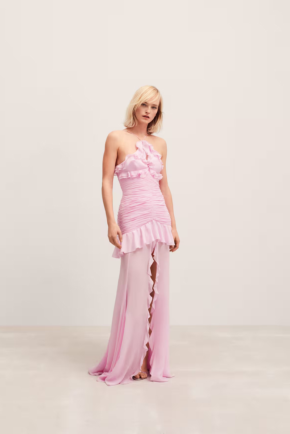 Pink wedding guest dress from Mango with halter neckline, draped design and ruffles