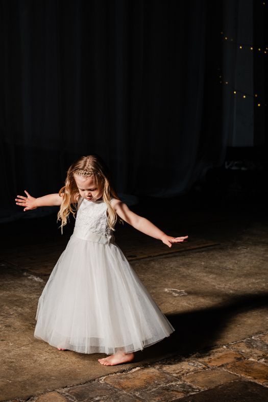 Flower girl dancing in window light 