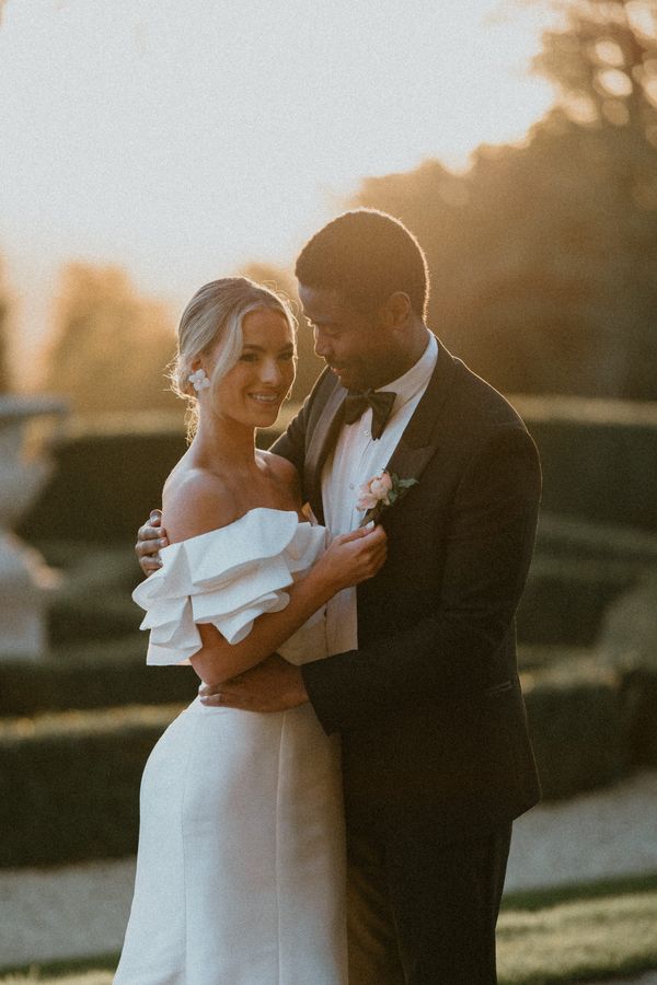 Sunset couples portrait, wearing a dress by Pronovias