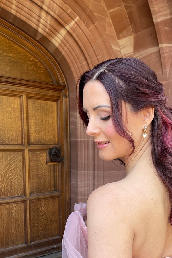 Bridal hair and makeup at Salt house, featuring a wedding dress by Caroline Chamberlain. 