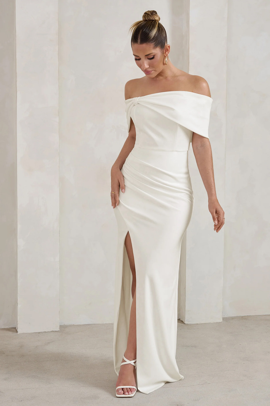 White bridal maxi dress from Club L London with bardot bow neckline and thigh split