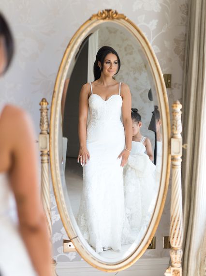bride looking at the mirror wearig weddig dress barlow suite   richard milnes