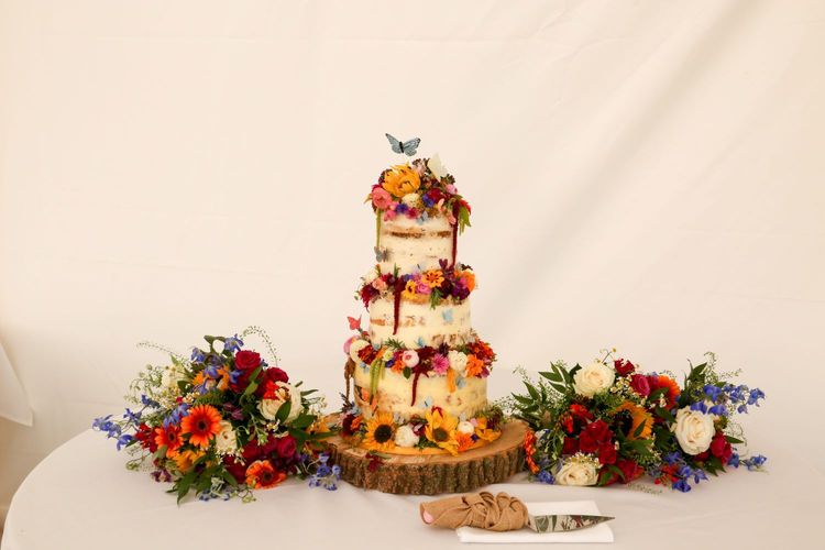 cocoa whey cakes semi naked with edible flowers with photo courtesy of cotswold weddings jane  oli for rmw