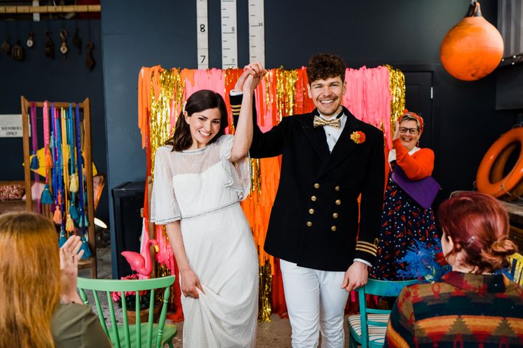 colourful wedding theme for ceremony at a boat shed