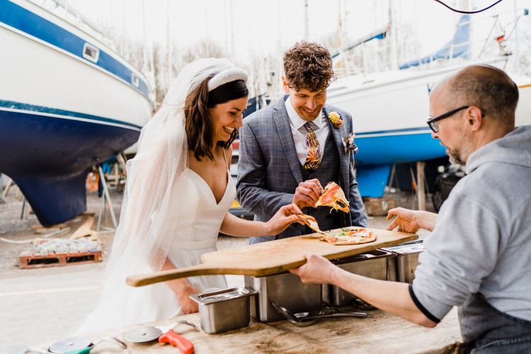 Bride and groom enjoying a pizza wedding breakfast