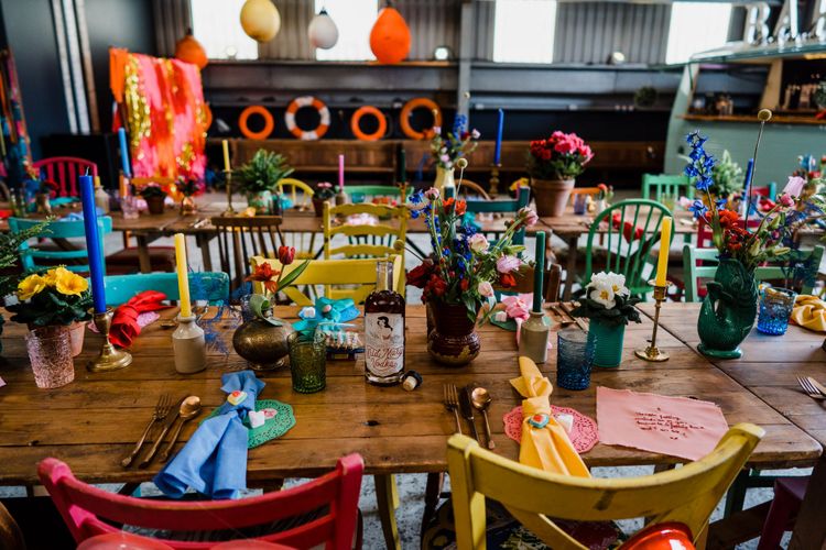 colourful wedding theme table decor with bright candles and vodka