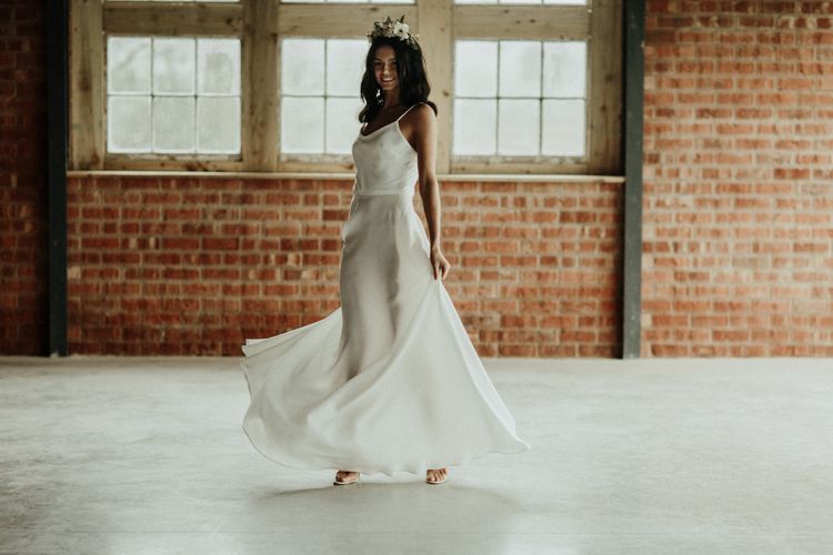 Bride in slinky wedding dress with spaghetti straps