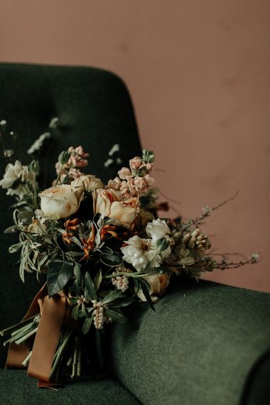 Muted flower wedding bouquet tied with ribbon.