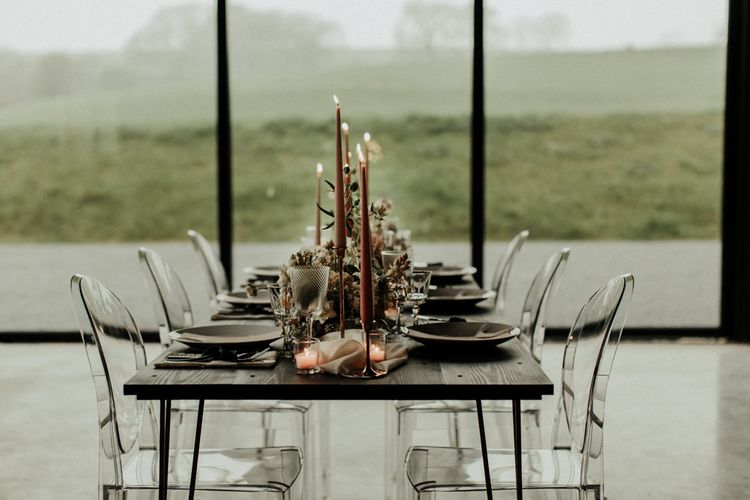 Elegant tablescape with coloured taper candles and ghost chairs